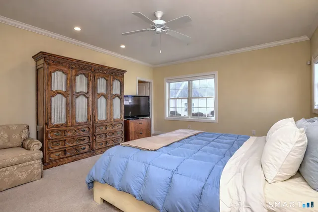 a bedroom with a bed dresser and a window