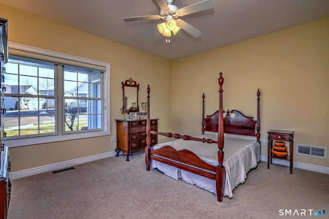 a bedroom with bed and a window