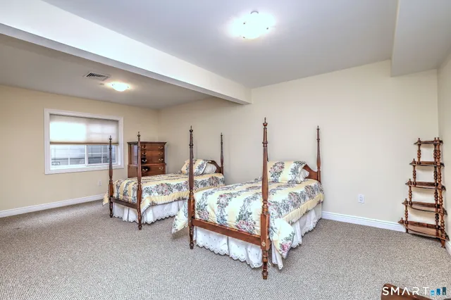 a bedroom with bed and a window