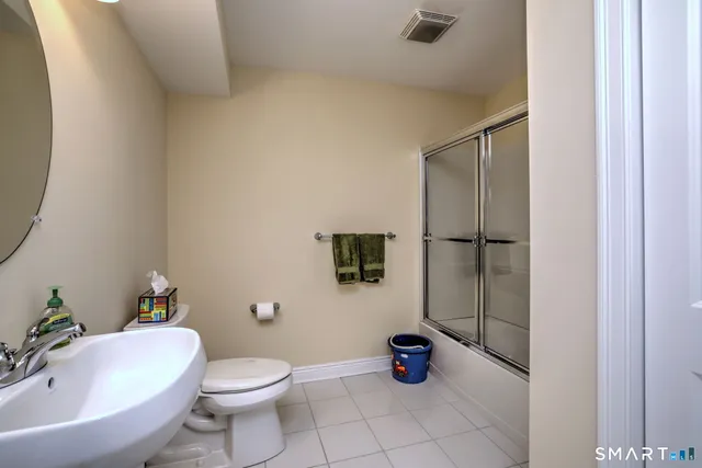 a white toilet sitting next to a bathroom sink