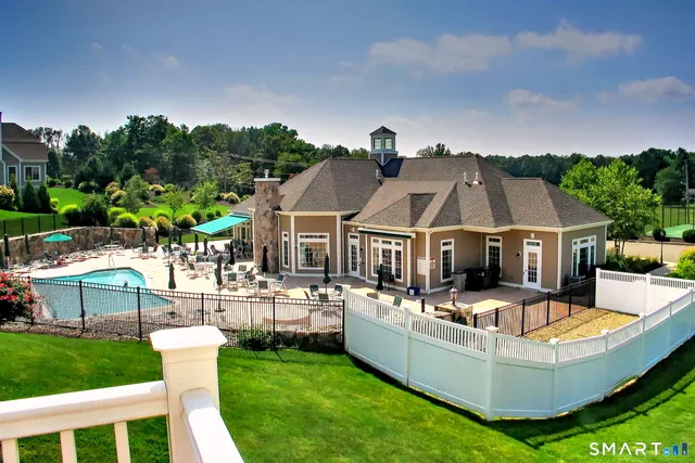 an aerial view of a house with a garden and lake view