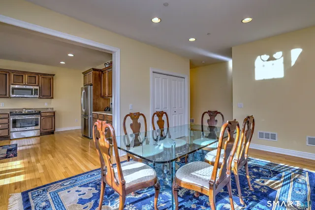 a dining room with furniture a rug and wooden floor