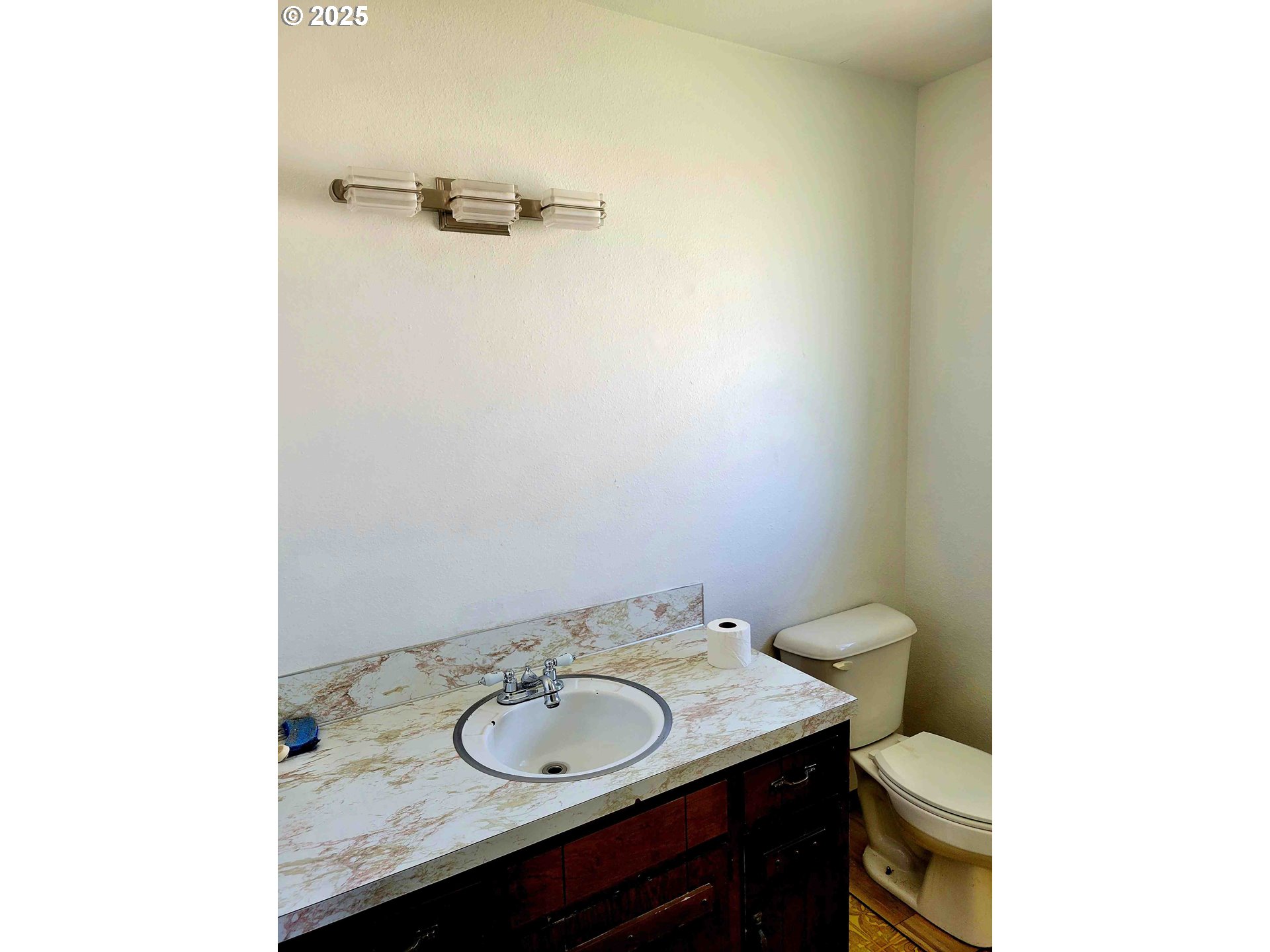 300 Maple Street Toledo, WA 98591 - Photo 11 of 19 a bathroom with a granite countertop sink and a toilet
