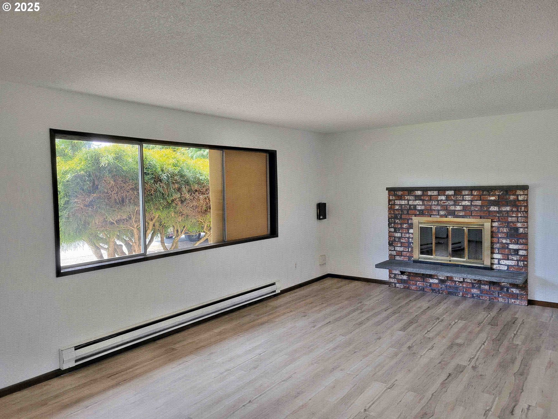 300 Maple Street Toledo, WA 98591 - Photo 3 of 19 a view of an empty room with wooden floor and a window