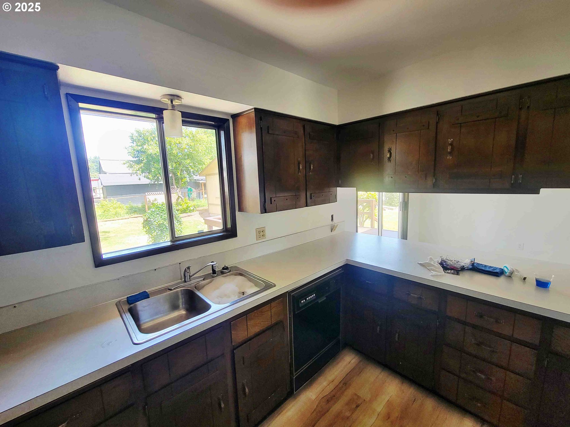 300 Maple Street Toledo, WA 98591 - Photo 4 of 19 a kitchen with a sink window and cabinets