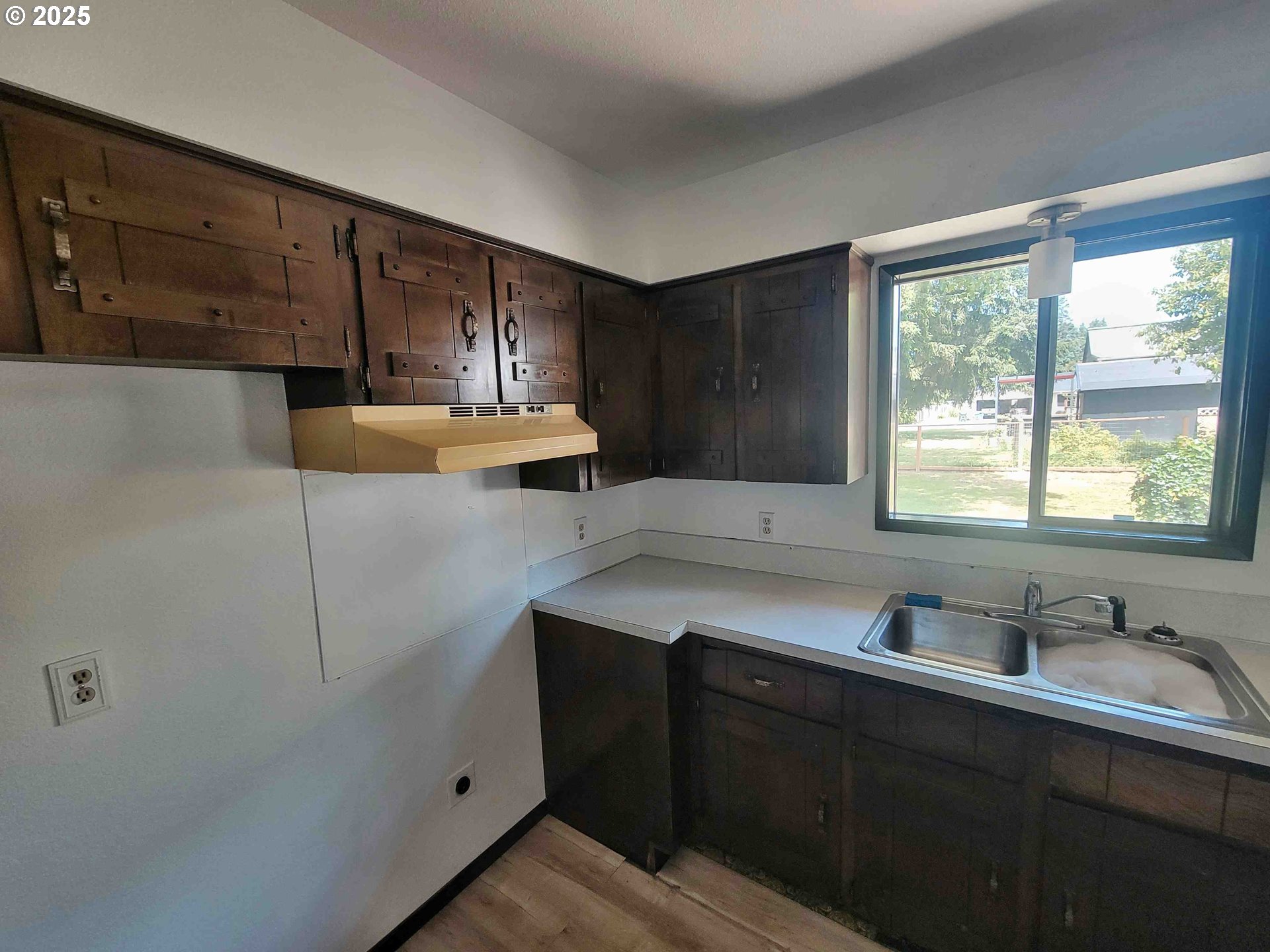 300 Maple Street Toledo, WA 98591 - Photo 6 of 19 a kitchen with a sink a window and cabinets