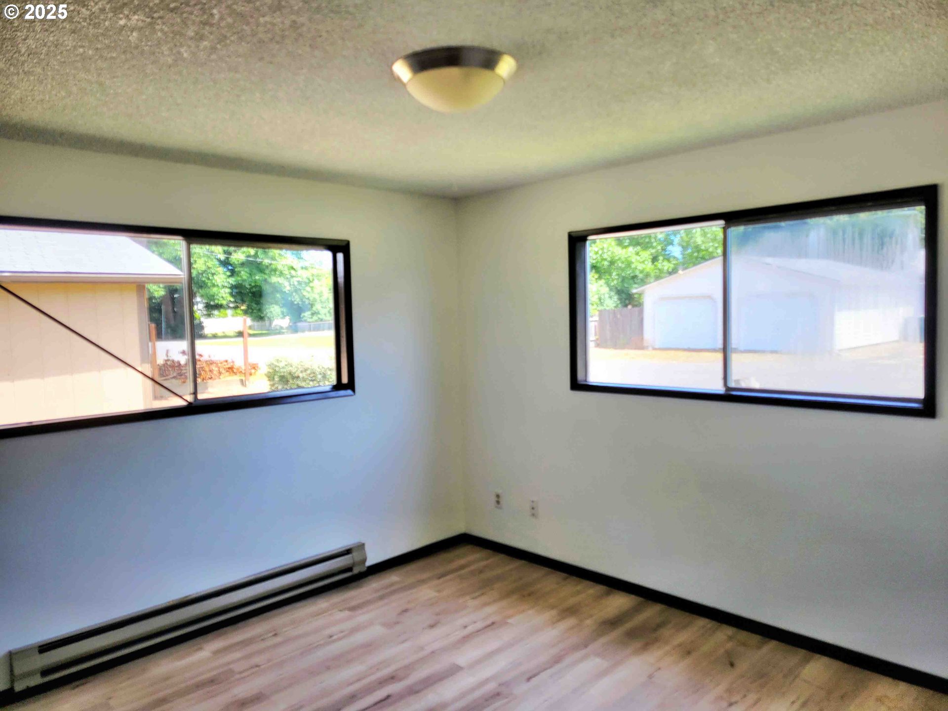 300 Maple Street Toledo, WA 98591 - Photo 8 of 19 a view of a room with wooden floor and a window