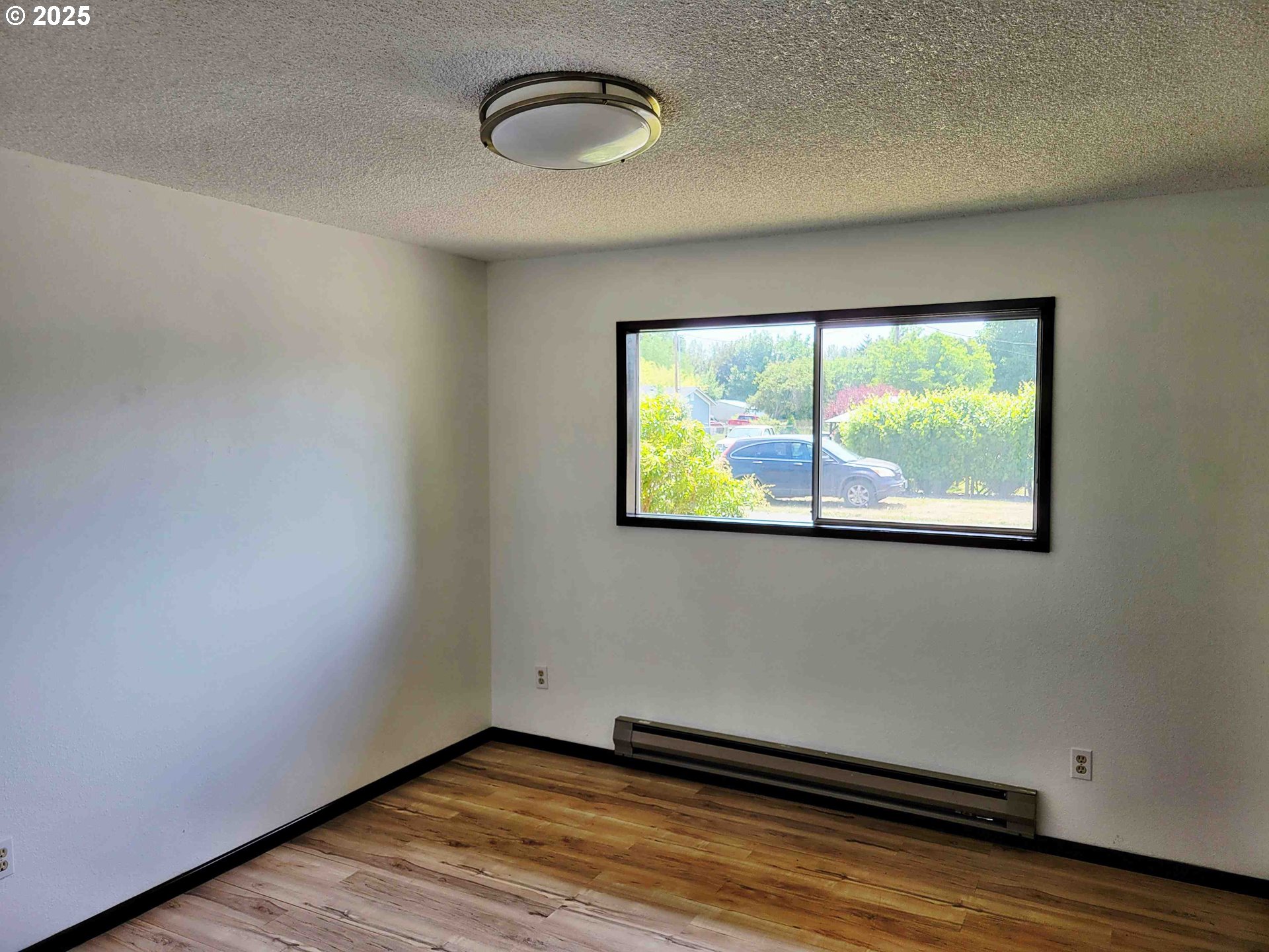 300 Maple Street Toledo, WA 98591 - Photo 9 of 19 a view of a room with wooden floor and window