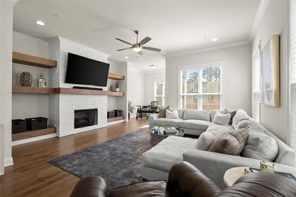 209 Phillips Lane Alpharetta, GA 30009 - Photo 12 of 48 a living room with furniture a fireplace and a flat screen tv