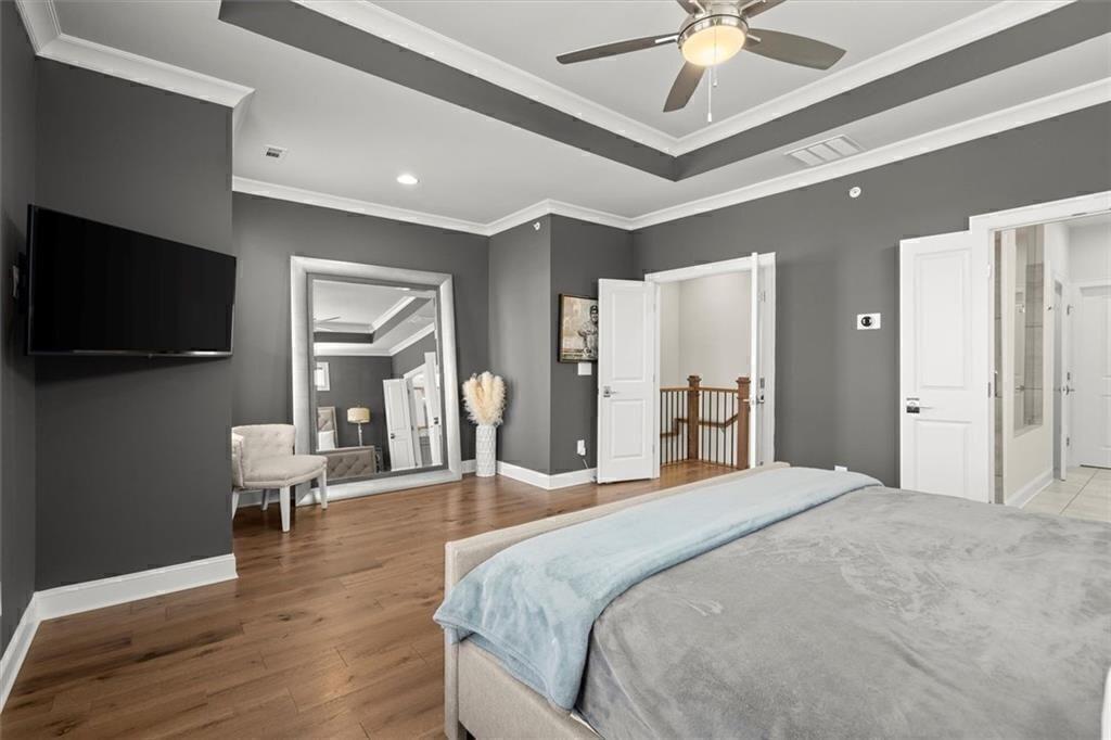 209 Phillips Lane Alpharetta, GA 30009 - Photo 19 of 48 a spacious bedroom with a bed and a flat screen tv
