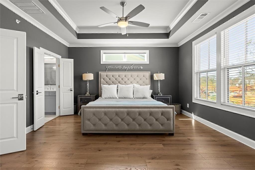 209 Phillips Lane Alpharetta, GA 30009 - Photo 21 of 48 a spacious bedroom with a bed and a large window