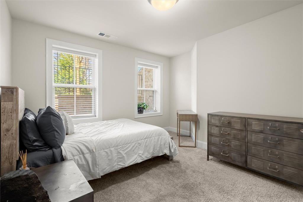 209 Phillips Lane Alpharetta, GA 30009 - Photo 30 of 48 a bedroom with a bed and furniture