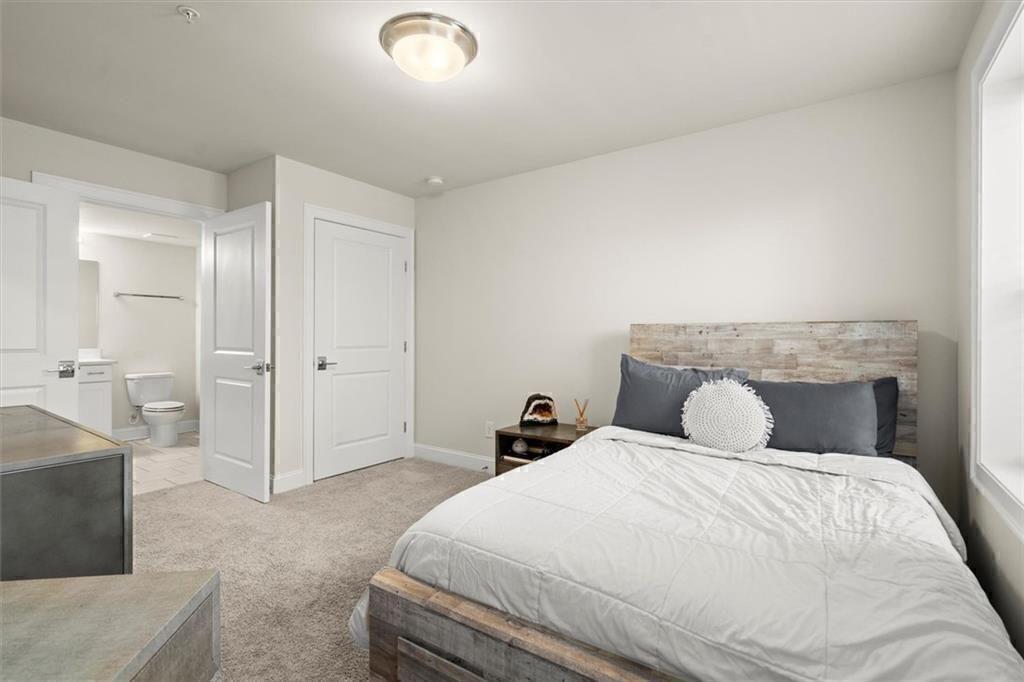 209 Phillips Lane Alpharetta, GA 30009 - Photo 31 of 48 a bedroom with a large bed and a couch