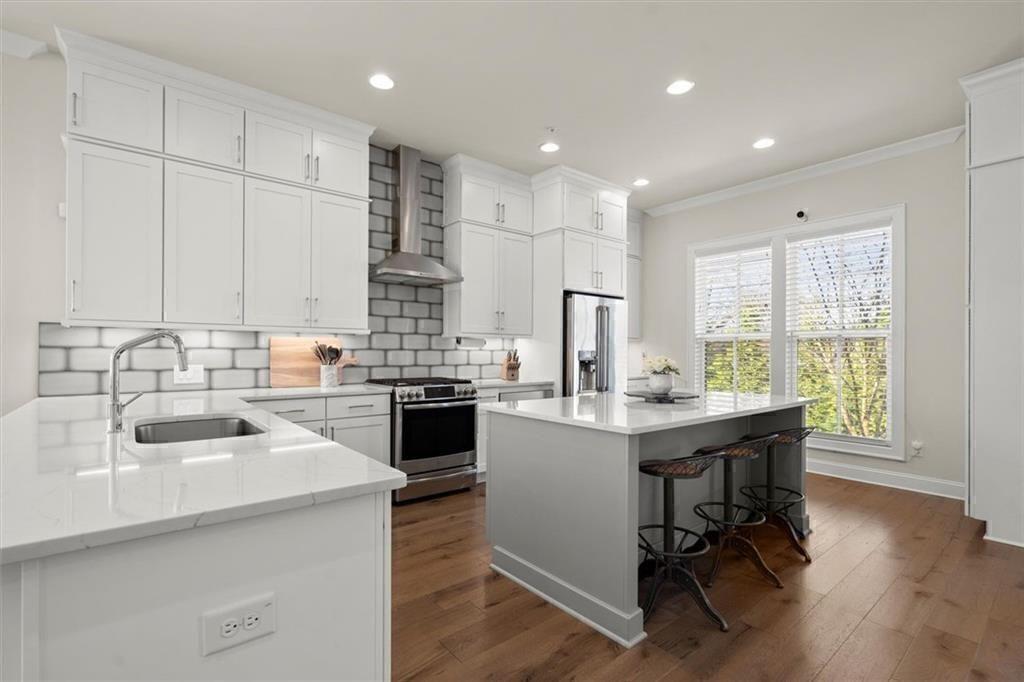 209 Phillips Lane Alpharetta, GA 30009 - Photo 5 of 48 a kitchen with stainless steel appliances kitchen island granite countertop a sink and cabinets
