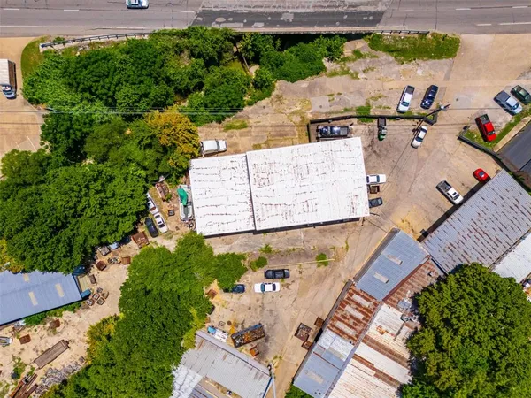 an aerial view of a house with a garden and lake view