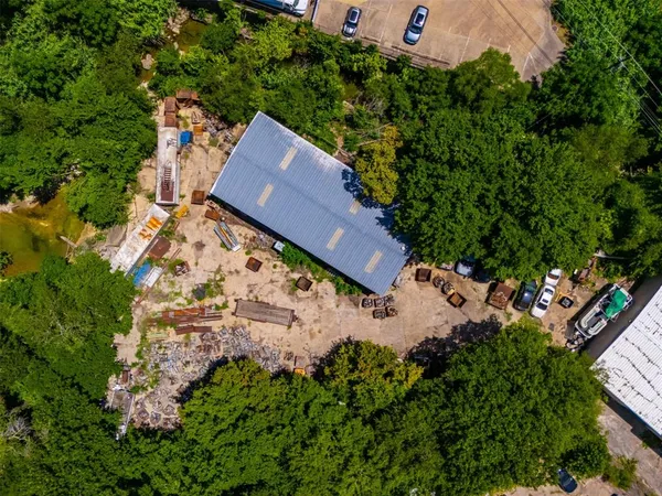 an aerial view of a house with garden space and street view