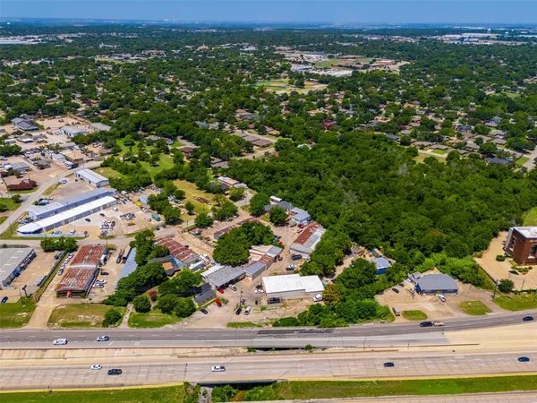 an aerial view of a house with a garden and lake view