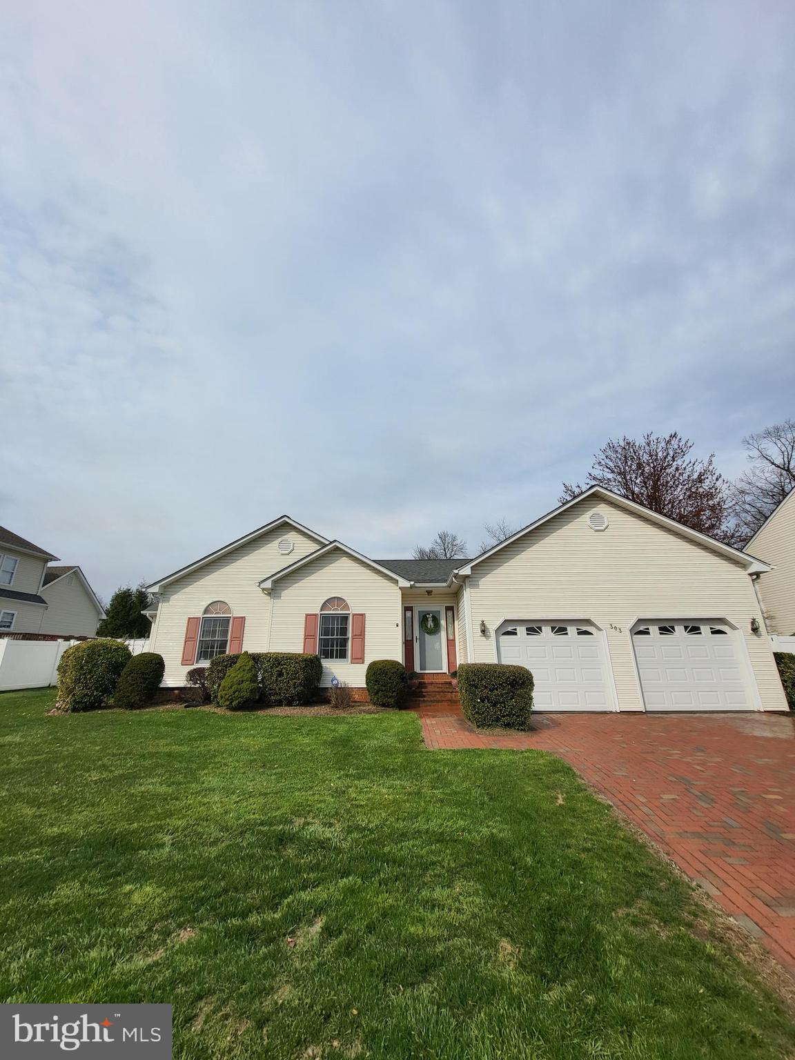 a view of a house with a yard and garage