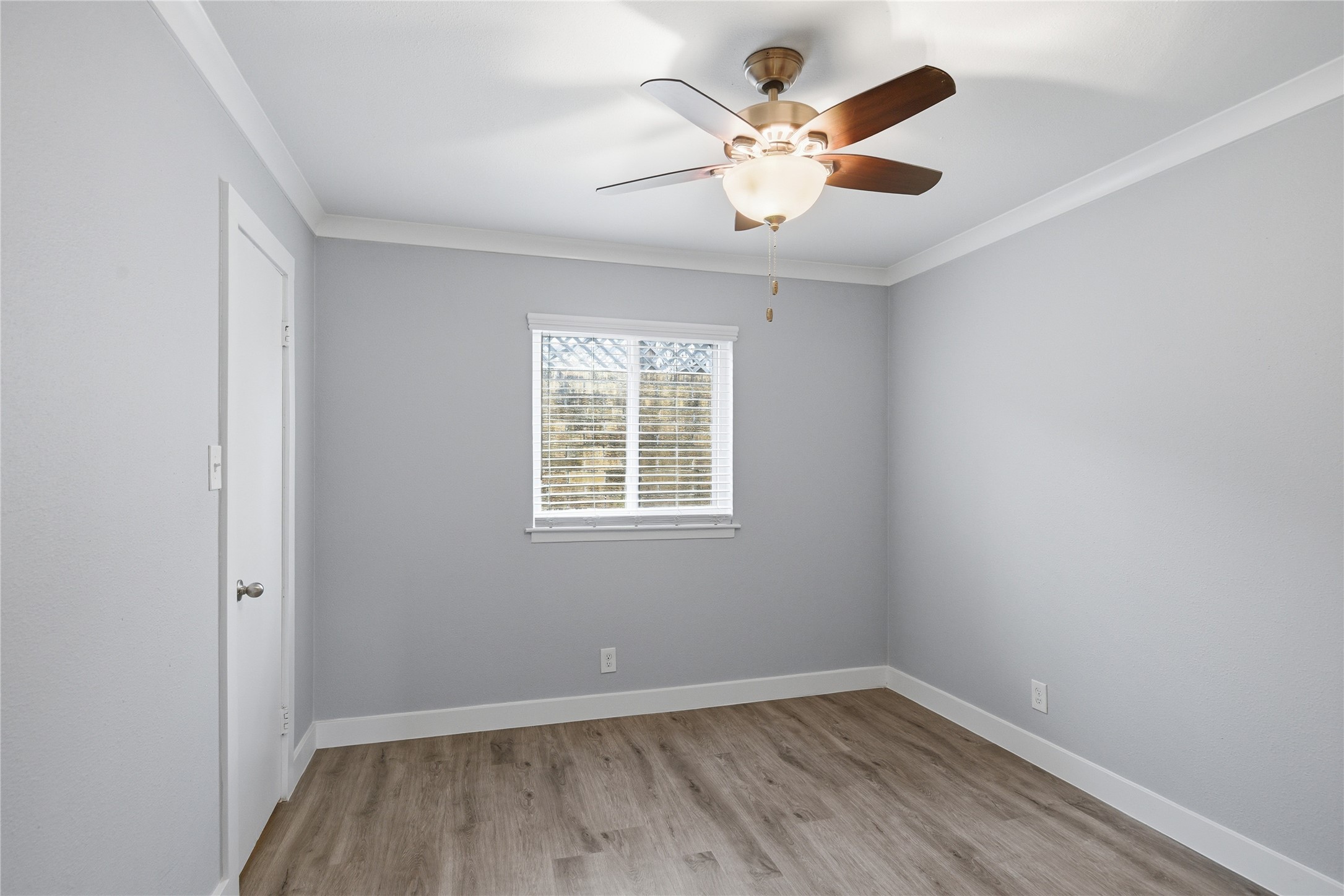 2401 Manor Road, Unit 232 Austin, TX 78722 - Photo 12 of 32 an empty room with a window and a fan