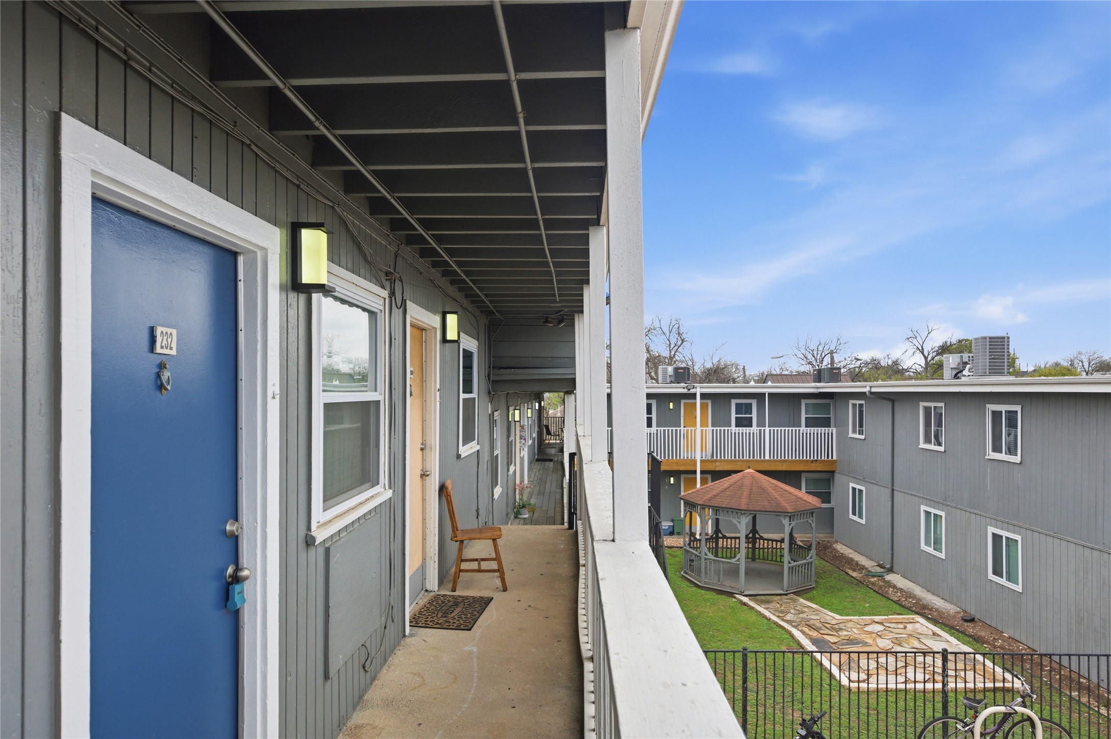2401 Manor Road, Unit 232 Austin, TX 78722 - Photo 17 of 32 a view of a balcony with chair and dining table