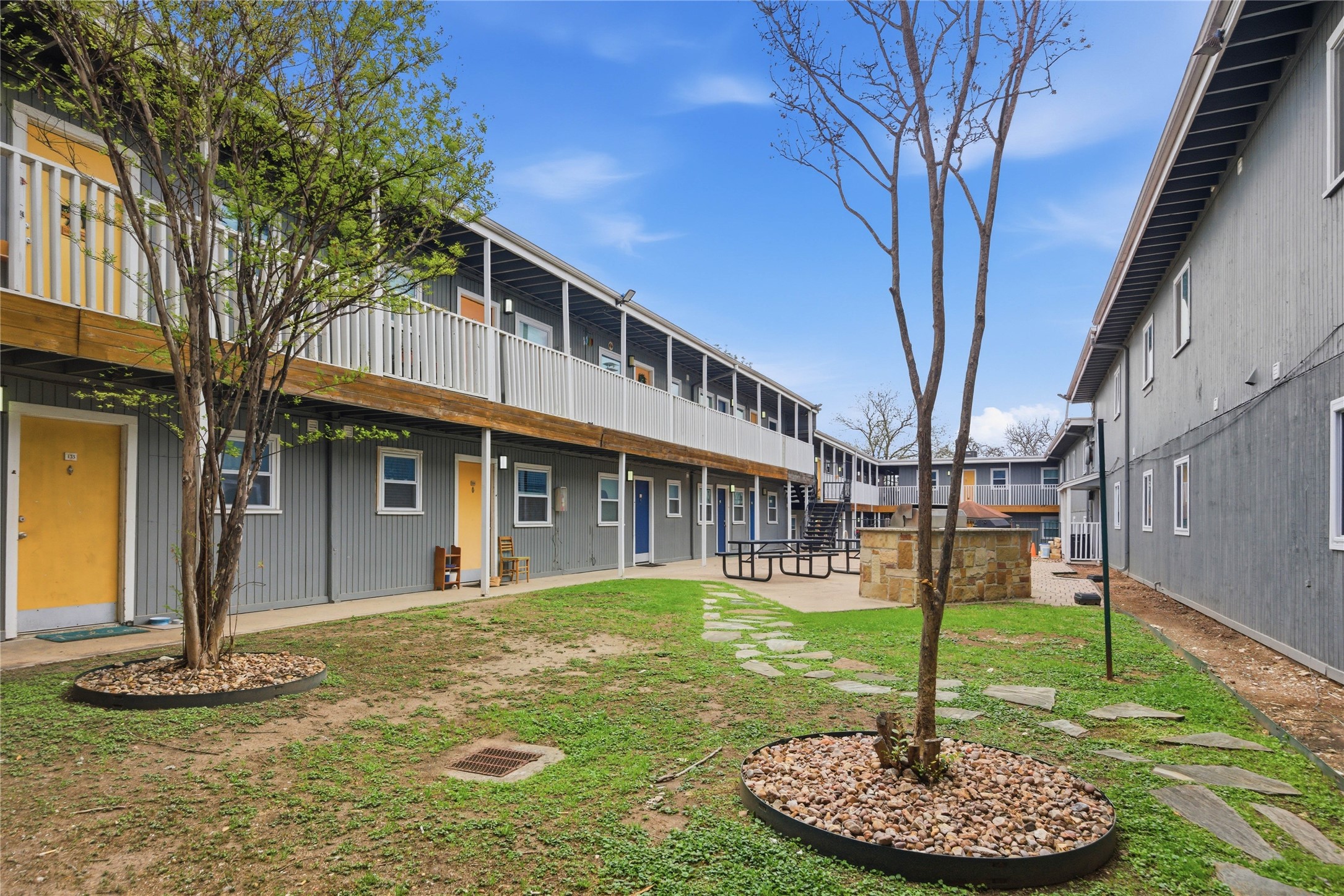 2401 Manor Road, Unit 232 Austin, TX 78722 - Photo 20 of 32 a front view of a house with a yard