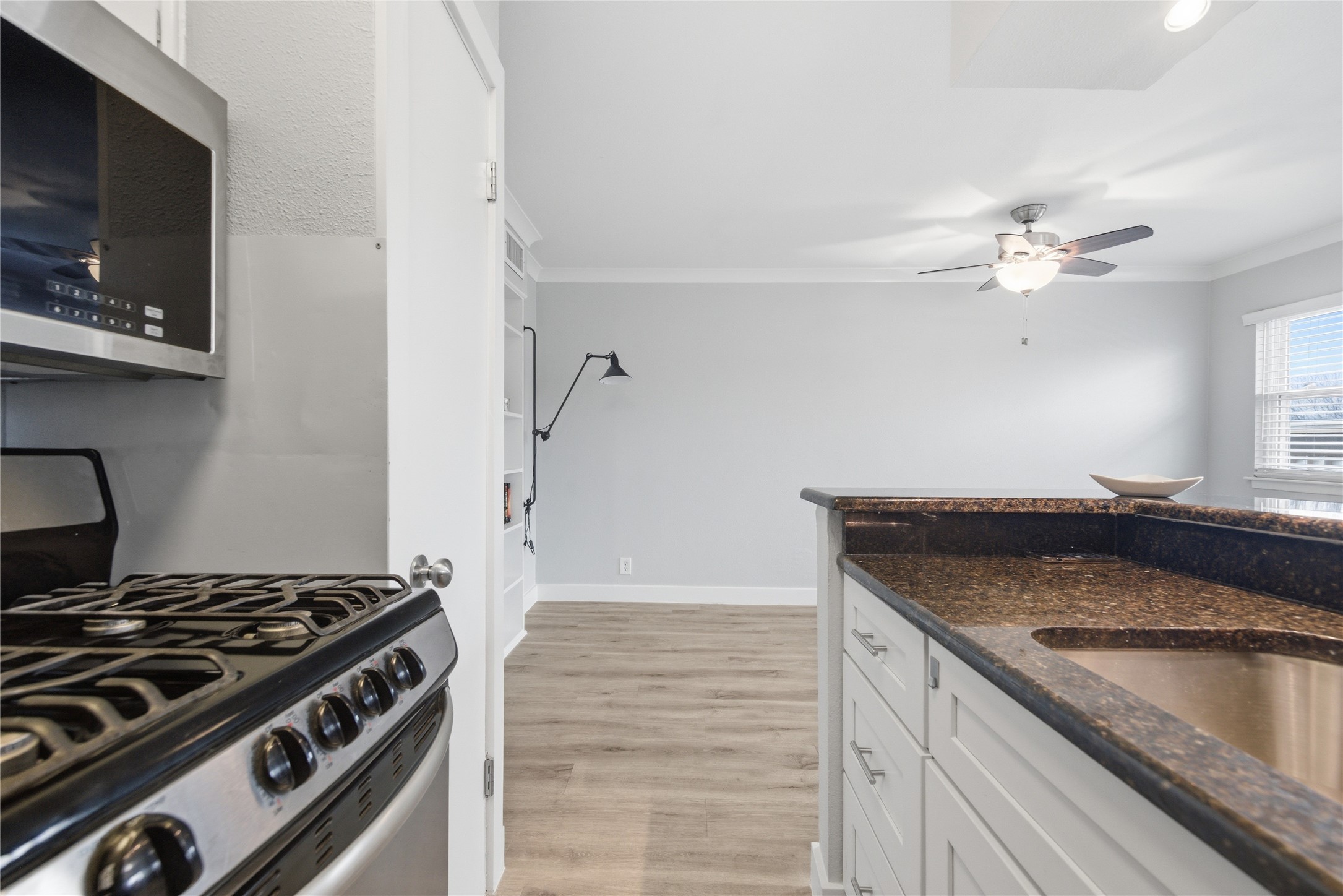 2401 Manor Road, Unit 232 Austin, TX 78722 - Photo 8 of 32 a kitchen with a stove and a microwave