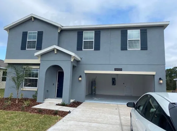 a front view of a house with garage