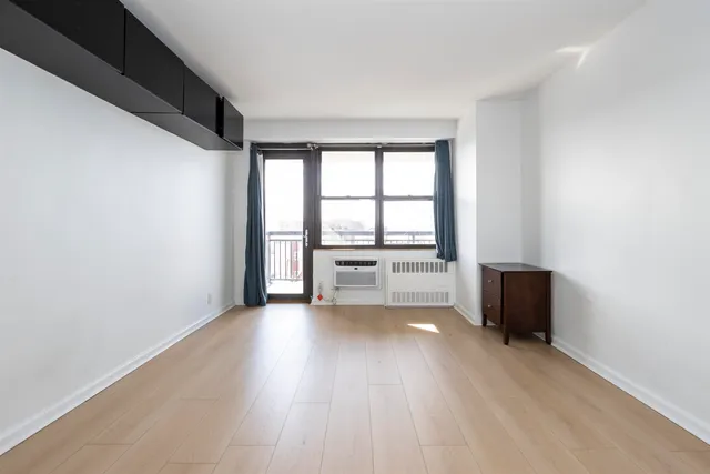 a living room with furniture a rug and a large window