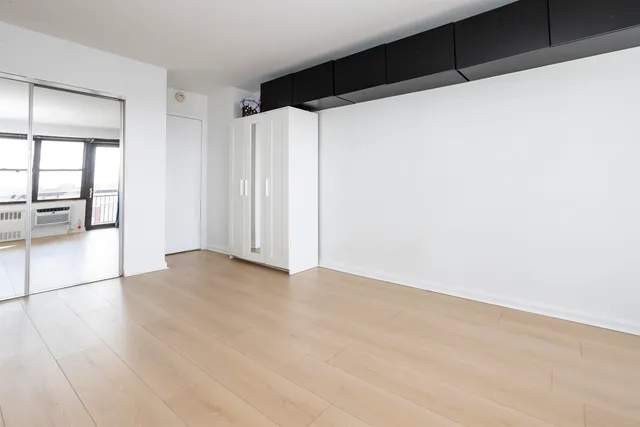 a living room with wooden floor and a table
