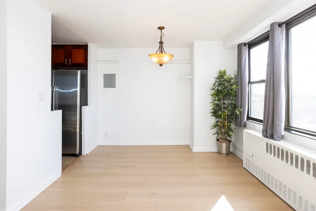 a spacious bedroom with a balcony a bed and a large window