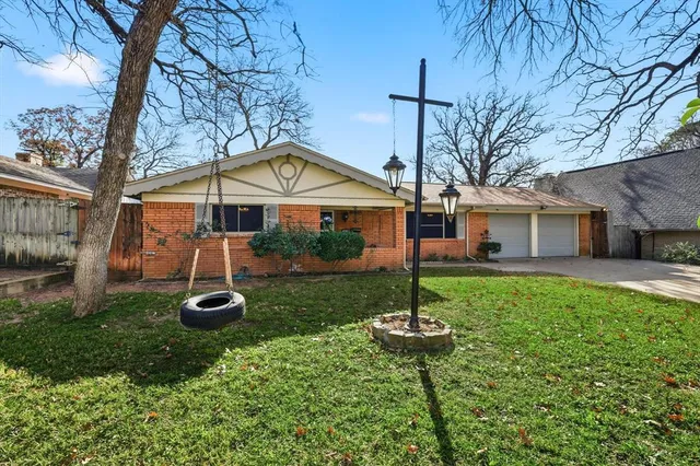 a front view of a house with a yard and table and chairs