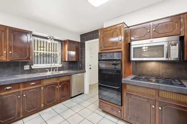 a kitchen with a refrigerator and a sink