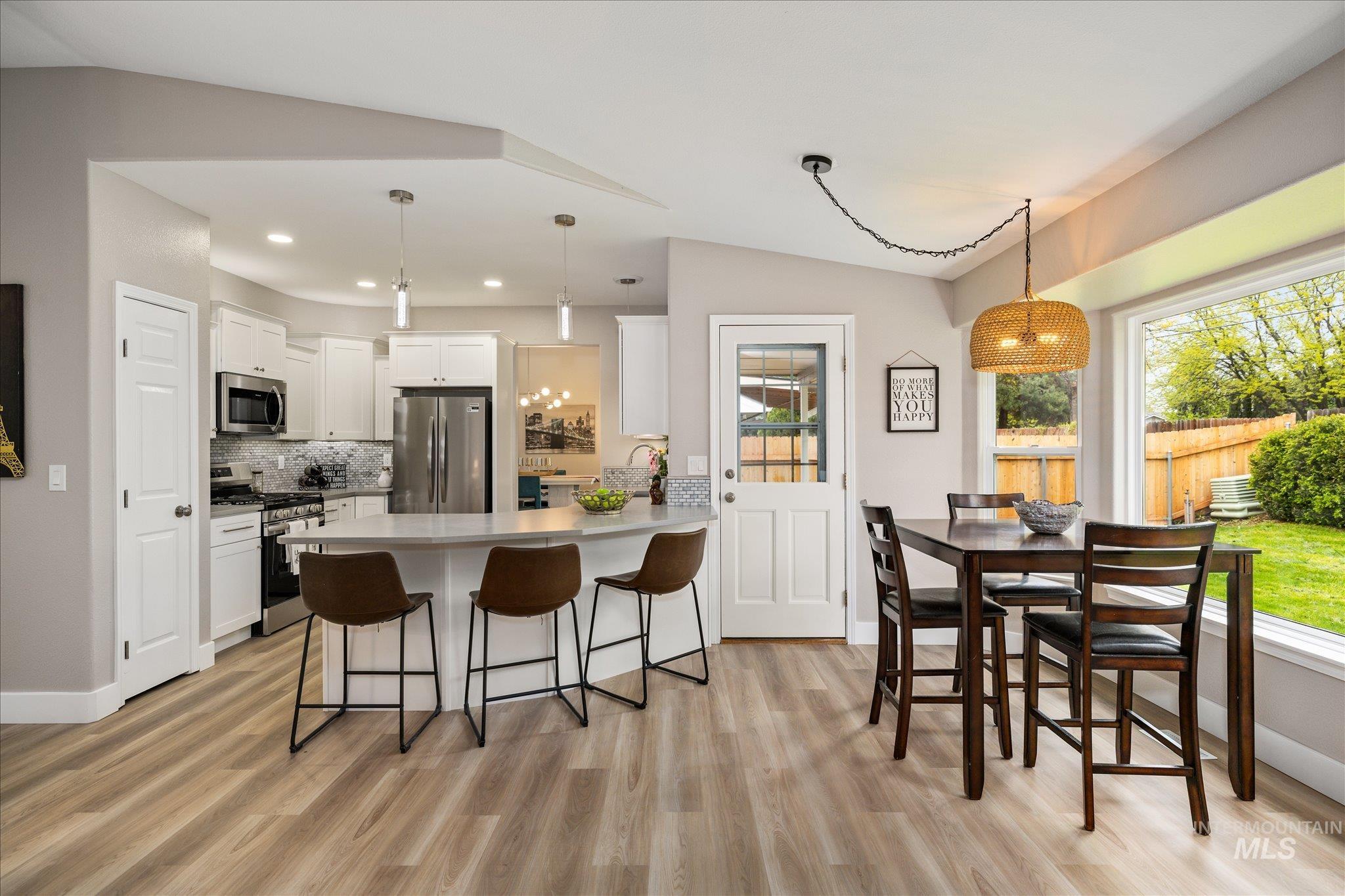 2250 North Amethyst Avenue Meridian, ID 83646 - Photo 22 of 50 Kitchen featuring a peninsula, stainless steel appliances, light countertops, a breakfast bar, and white cabinets