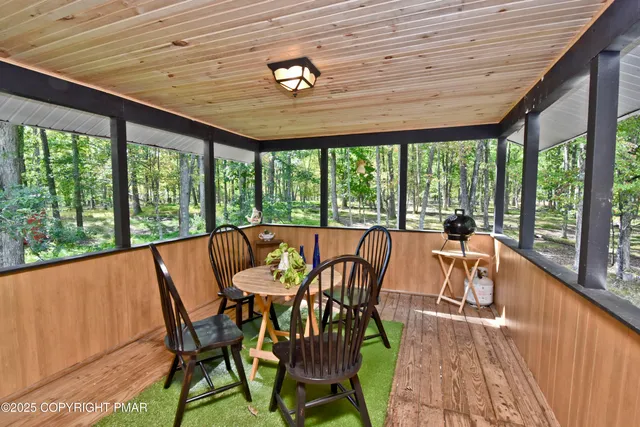 a dining room with furniture and balcony view