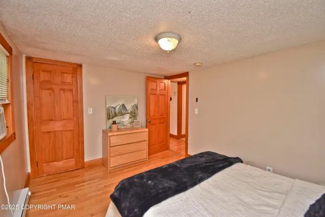 a bedroom with a bed and a dresser