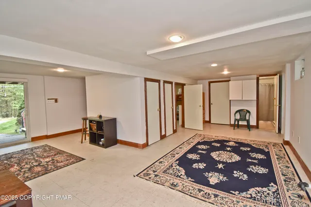 a large bedroom with a rug and a window