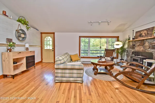 a living room with fireplace furniture and a wooden floor