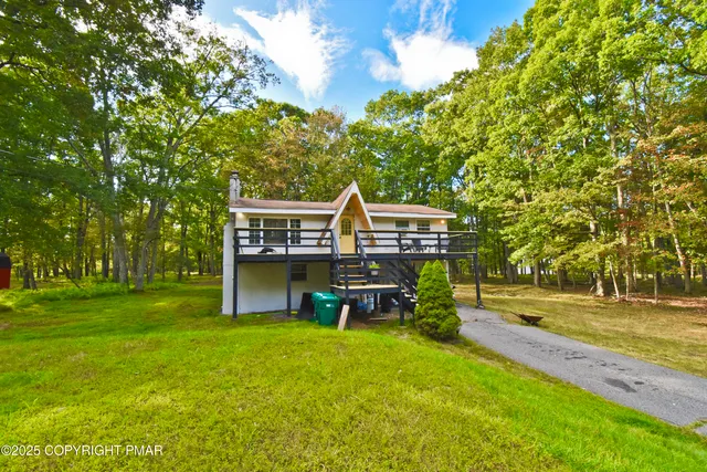 a view of a house with a backyard and a patio