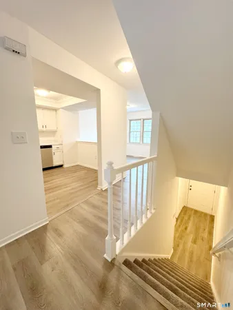 a view of a bedroom with wooden floor and windows