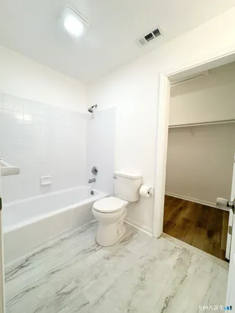 a bathroom with a toilet a sink and bathtub