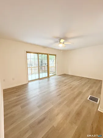 wooden floor in an empty room with a window