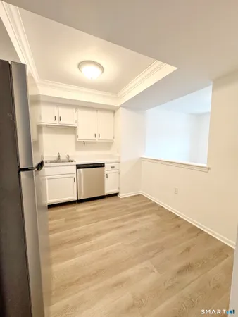 a view of a kitchen with a sink and a refrigerator