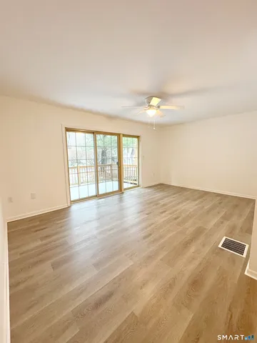 wooden floor in an empty room with a window