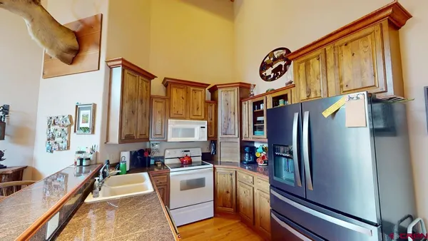 a kitchen with stainless steel appliances granite countertop a refrigerator and a stove
