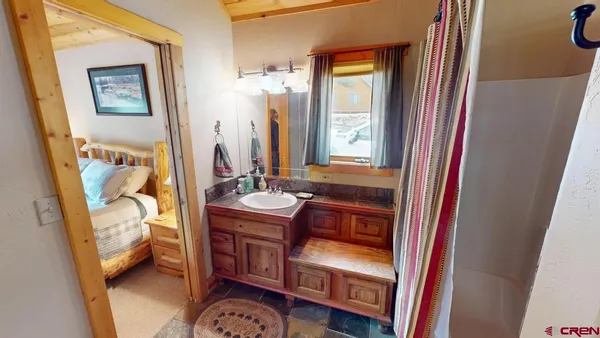 a bedroom with three beds and a window