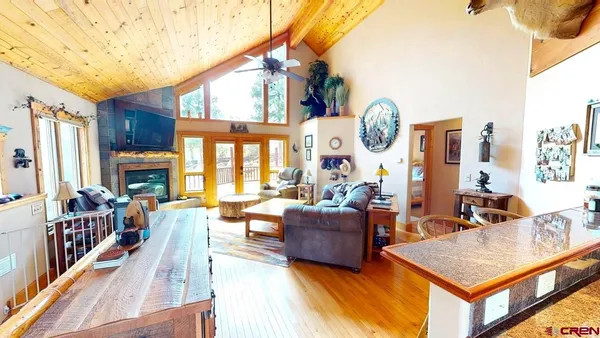 a living room with fireplace furniture and a large window