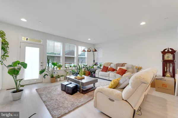 a living room with furniture and a potted plant