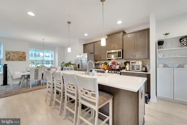 a kitchen with appliances a sink and cabinets