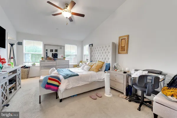 a bed room with furniture and a flat screen tv