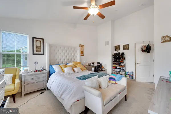 a bedroom with bed and a window